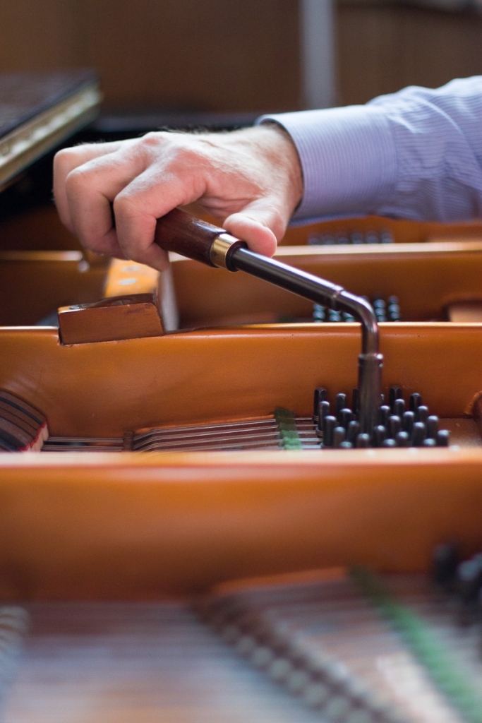 Hand tuning a piano